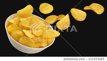 Falling ridged potato chips in bowl isolated on black background, package design element Falling ridged potato chips in bowl isolated on black background, package design element 121431665