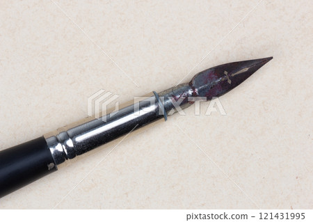 Fountain pen on an antique textured paper. 121431995