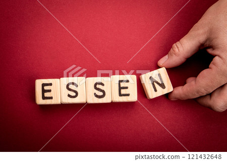 ESSEN. Word from wooden alphabet blocks on a red background 121432648