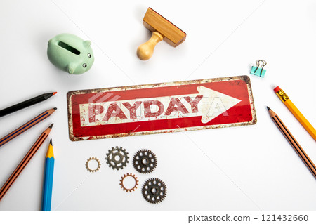 Payday. Red direction arrow with text on white office desk 121432660