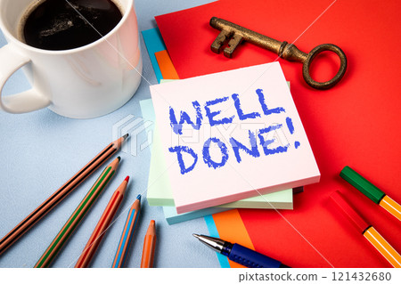 WELL DONE. Notepad with text, coffee mug and golden key on office table WELL DONE. Notepad with text, coffee mug and golden key on office table 121432680