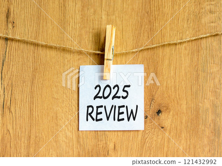 Planning 2025 review new year symbol. Concept words 2025 Review on beautiful white paper on wooden clothespin. Beautiful wooden background. Business 2025 review new year concept. Copy space. Planning 2025 review new year symbol. Concept words 2025 Review on beautiful white paper on wooden clothespin. Beautiful wooden background. Business 2025 review new year concept. Copy space. 121432992