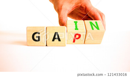 Gain or gap symbol. Concept words Gain Gap on wooden block. Beautiful white table white background. Businessman hand. Business gain or gap concept. Copy space. 121433016