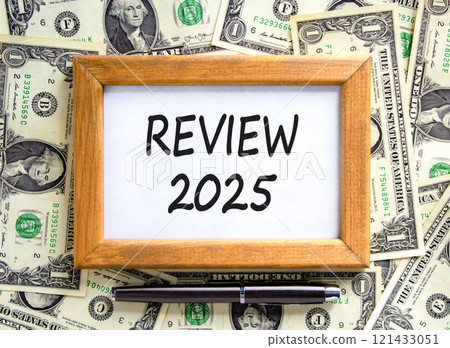 Planning review 2025 new year symbol. Concept words Review 2025 on beautiful wooden picture frame. Beautiful background from dollar bills. Black pen. Business review 2025 new year concept. Copy space. 121433051