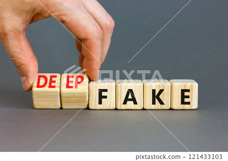Deepfake or fake symbol. Concept words Fake Deepfake on wooden cubes. Beautiful grey table grey background. Businessman hand. Business and deepfake or fake concept. Copy space. Deepfake or fake symbol. Concept words Fake Deepfake on wooden cubes. Beautiful grey table grey background. Businessman hand. Business and deepfake or fake concept. Copy space. 121433103