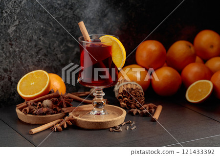 Mulled wine with ingredients on a black kitchen table. Mulled wine with ingredients on a black kitchen table. 121433392