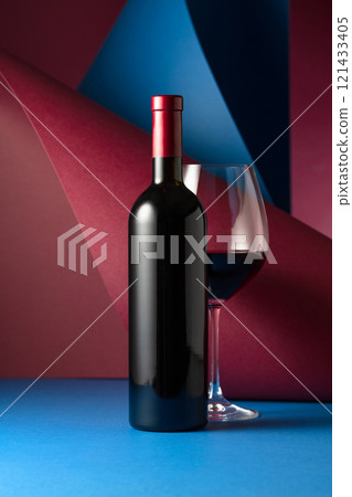 Bottle and glass of red wine. 121433405