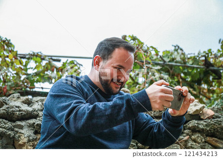 Focused Man Enjoying Intense Mobile Game Focused Man Enjoying Intense Mobile Game 121434213