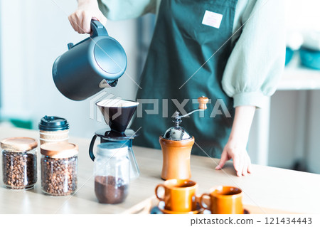 Young woman brewing coffee at home, no face Young woman brewing coffee at home, no face 121434443