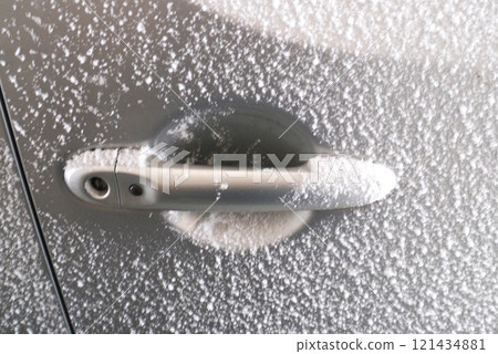 On a sub-zero morning, melt the frozen car door until it's completely open. 121434881