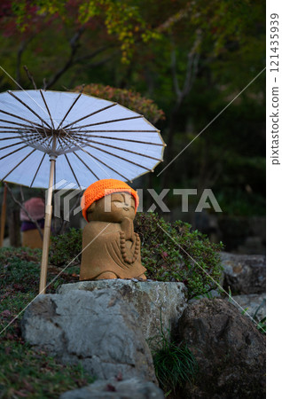 Jizo holding a Japanese umbrella 121435939