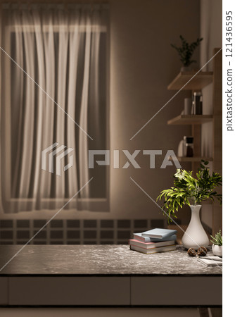 A close-up of a black marble table in a minimalist room illuminated by cozy, warm light. 121436595