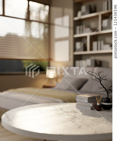 A close-up of a white marble table set against a blurred background of a comfortable modern bedroom. A close-up of a white marble table set against a blurred background of a comfortable modern bedroom. 121436596