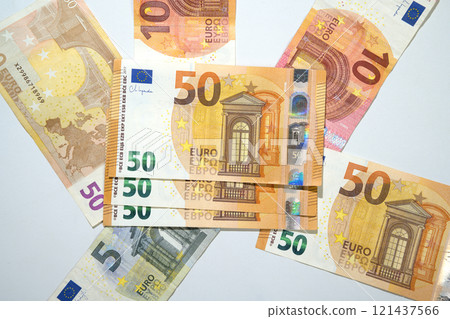 Top view of a pile of euro banknote cash on a white background Top view of a pile of euro banknote cash on a white background 121437566