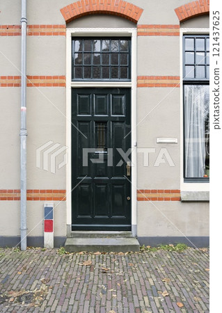 The facade of the house with glass of windows and black front door in Amsterdam, Netherlands The facade of the house with glass of windows and black front door in Amsterdam, Netherlands 121437625