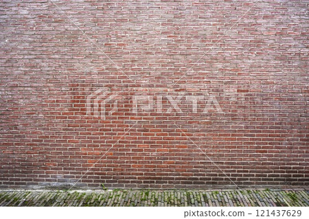 Closeup view of the red floor and wall. Abstract pattern of a brick wall and floor 121437629