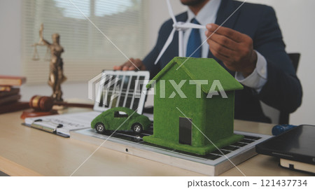 Auctioneer knocks down property sale by sample house and lawyer's gavel, judge mediates in property dispute in court car judge's gavel on wooden background Buying and selling real estate, housing 121437734