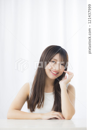 A young woman looks in the mirror and worries about her skin A young woman looks in the mirror and worries about her skin 121437999