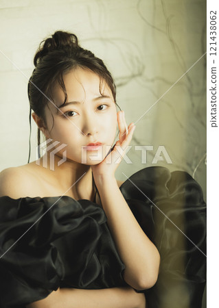 A woman in a black dress 121438062