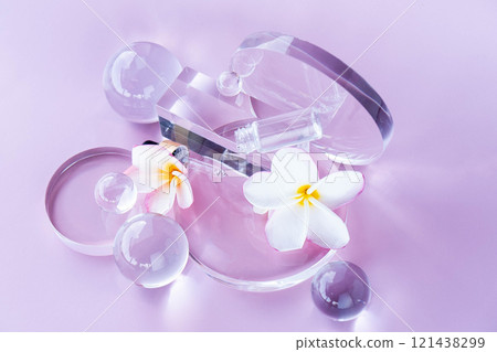 Cosmetic elements artfully arranged on a soft pink backdrop highlight aloe serum. 121438299