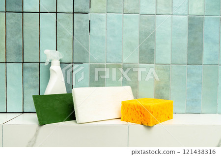 Cleaning tools are placed on a tiled surface, emphasizing restoration practices with epoxy grout. 121438316