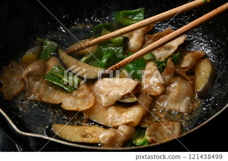 Stir-fried eggplant, green pepper, and pork with miso while cooking 121438499