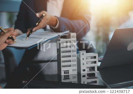 Real estate agent and customer signing contract to buy house, insurance or loan real estate.rent a house,get insurance or loan real estate or property. Real estate agent and customer signing contract to buy house, insurance or loan real estate.rent a house,get insurance or loan real estate or property. 121438717