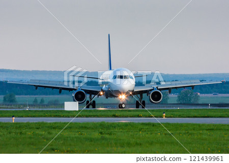 U-turn of a passenger jet plane on the runway. Front view 121439961