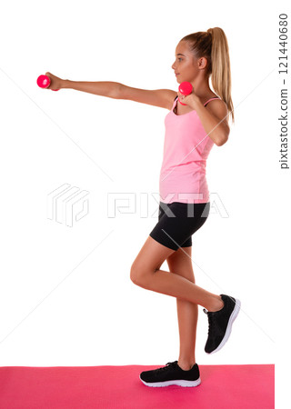Healthy fitness teen girl in full length doing exercises with dumbbells in profile isolated over white background Healthy fitness teen girl in full length doing exercises with dumbbells in profile isolated over white background 121440680