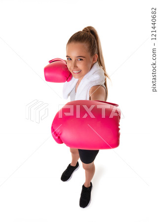 Healthy teen girl with boxing gloves working out with towel on shoulder. Isolated on white background. fitness gym concept. Wide angle shot. 121440682