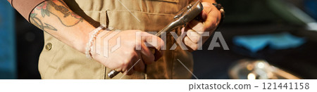Mechanic Repairing Car With Wrench 121441158