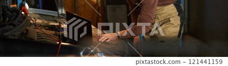 Technician Doing Online Diagnostics With Computer Technician Doing Online Diagnostics With Computer 121441159