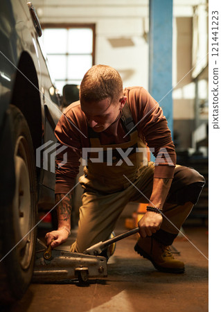 Worker Changing Wheels Of The Car 121441223