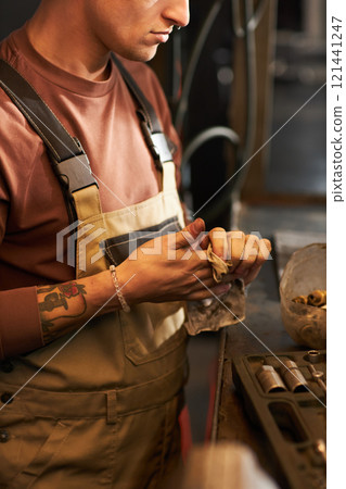 Mechanic Cleaning His Work Tools 121441247