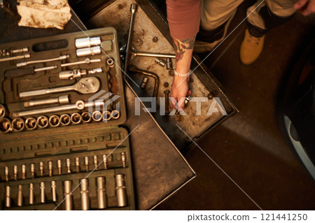 Worker Using Tools In His Work In Car Service 121441250