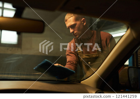 Car Washer Washing Windshield Of Car In Car Wash 121441259