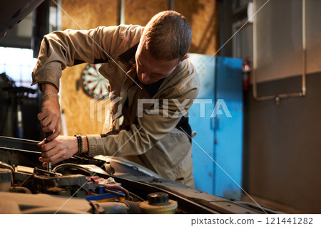 Mechanic Using Tools To Repair Engine Mechanic Using Tools To Repair Engine 121441282