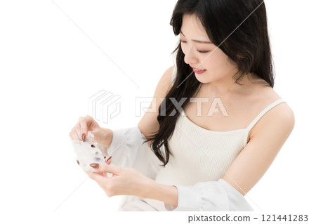 A young woman opening the lid of a supplement case A young woman opening the lid of a supplement case 121441283