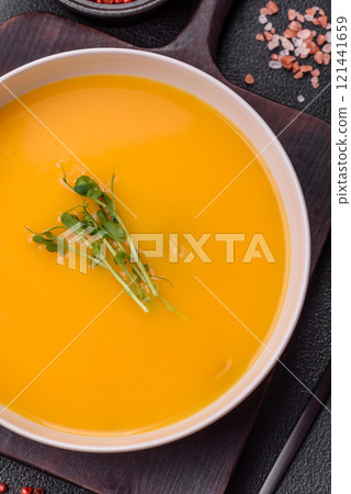 Cream soup of pumpkin, zucchini and carrots with salt and spices 121441659