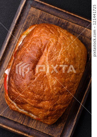 Ciabata with jamon or prosciutto, tomatoes, cheese and lettuce Ciabata with jamon or prosciutto, tomatoes, cheese and lettuce 121441725
