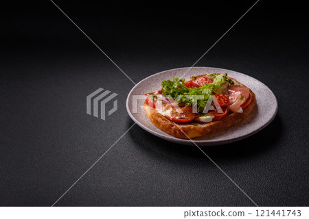 Ciabata with jamon or prosciutto, tomatoes, cheese and lettuce Ciabata with jamon or prosciutto, tomatoes, cheese and lettuce 121441743