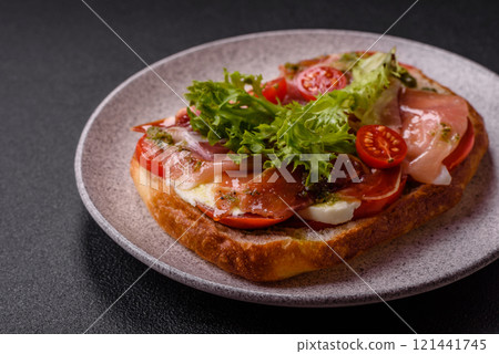 Ciabata with jamon or prosciutto, tomatoes, cheese and lettuce 121441745