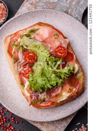 Ciabata with jamon or prosciutto, tomatoes, cheese and lettuce 121441750