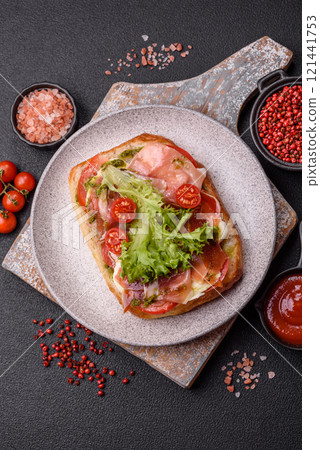 Ciabata with jamon or prosciutto, tomatoes, cheese and lettuce Ciabata with jamon or prosciutto, tomatoes, cheese and lettuce 121441753