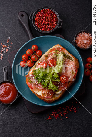Ciabata with jamon or prosciutto, tomatoes, cheese and lettuce Ciabata with jamon or prosciutto, tomatoes, cheese and lettuce 121441756