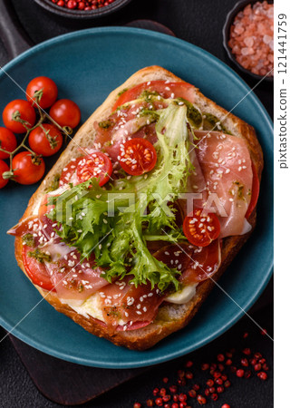 Ciabata with jamon or prosciutto, tomatoes, cheese and lettuce Ciabata with jamon or prosciutto, tomatoes, cheese and lettuce 121441759