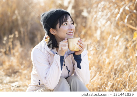 A woman drinking hot coffee A woman drinking hot coffee 121441829