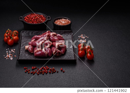 Raw chicken hearts with salt, spices and herbs 121441902