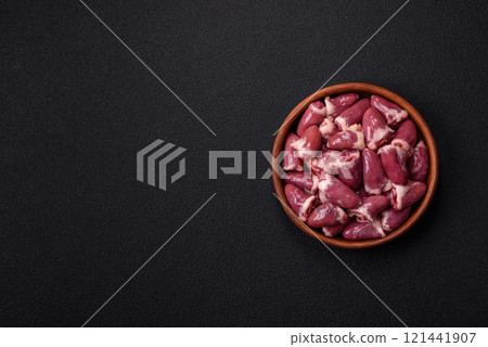 Raw chicken hearts with salt, spices and herbs 121441907