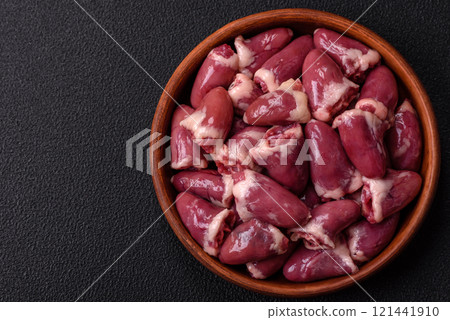 Raw chicken hearts with salt, spices and herbs 121441910
